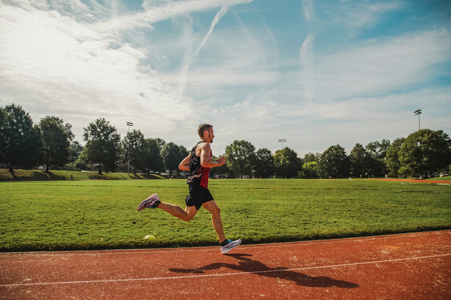 high school or college man running on track